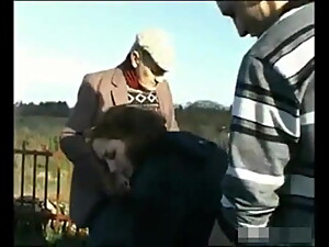 A young couple and an old man outdoors